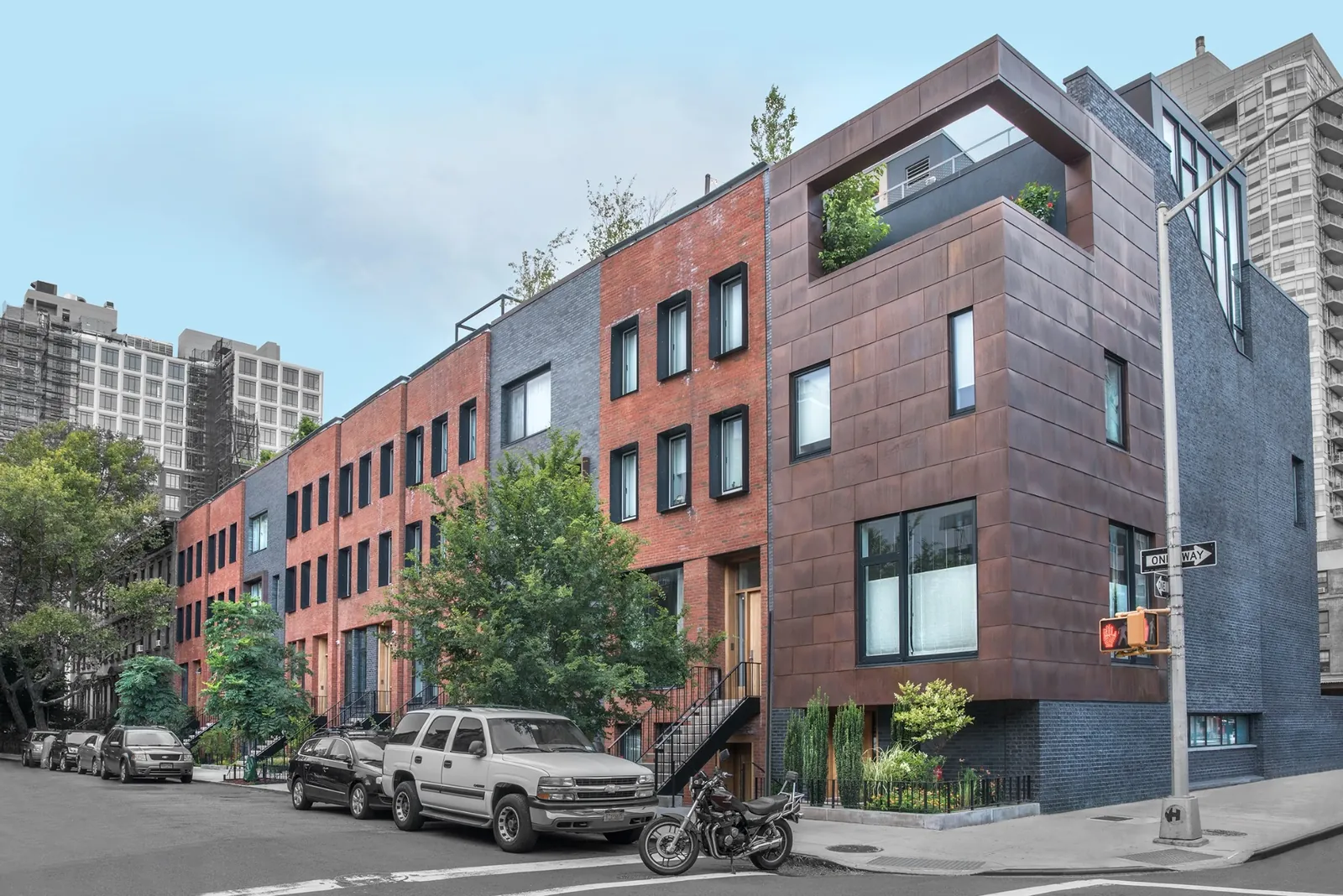 Modern row of rental townhomes at a street corner on the Brooklyn and Queens border.